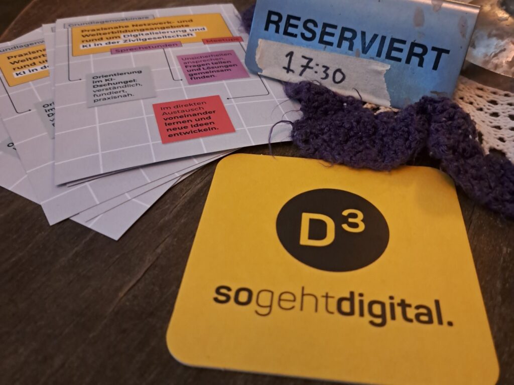 Auf einem Bierdeckel ist das Logo von D3. Daneben steht ein kleiner Aufsteller, auf dem steht: Reserviert ab 17:30.